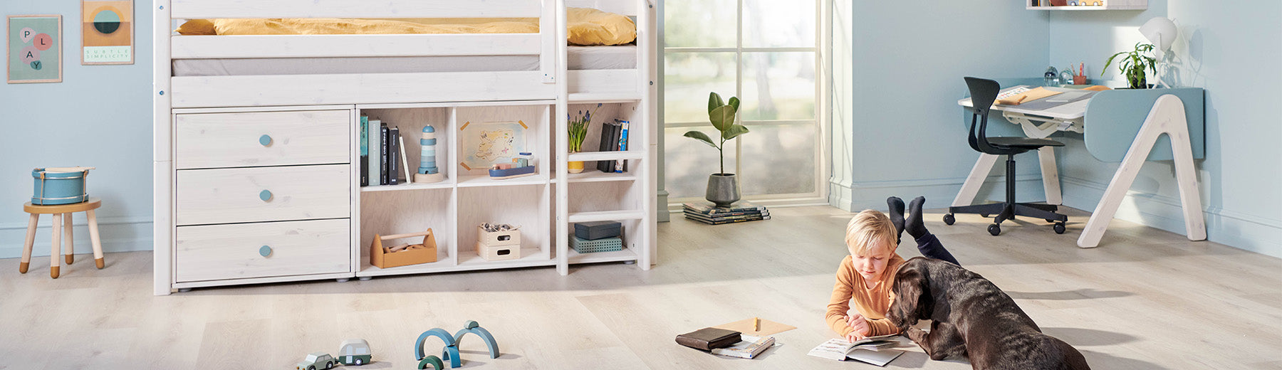 boy laying next to his bed with storage solution