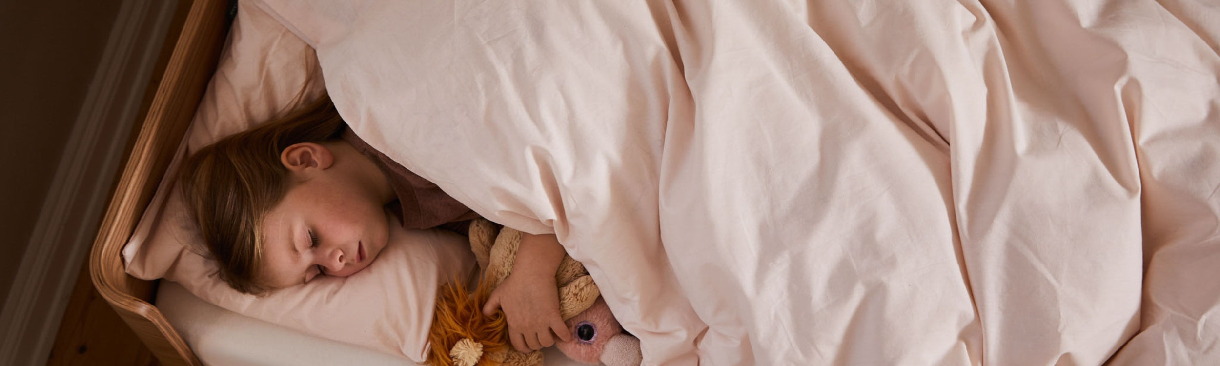 bed with a duvet and pillow from FLEXA