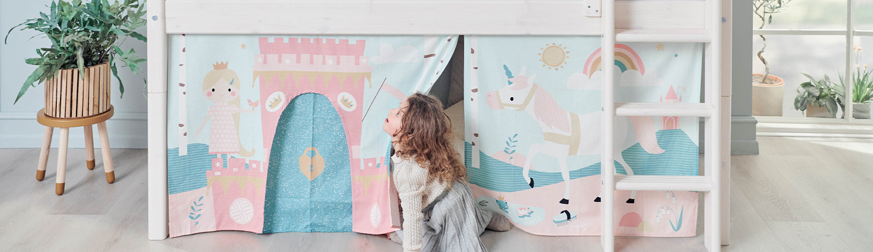 Girl is playing with play curtains from FLEXA