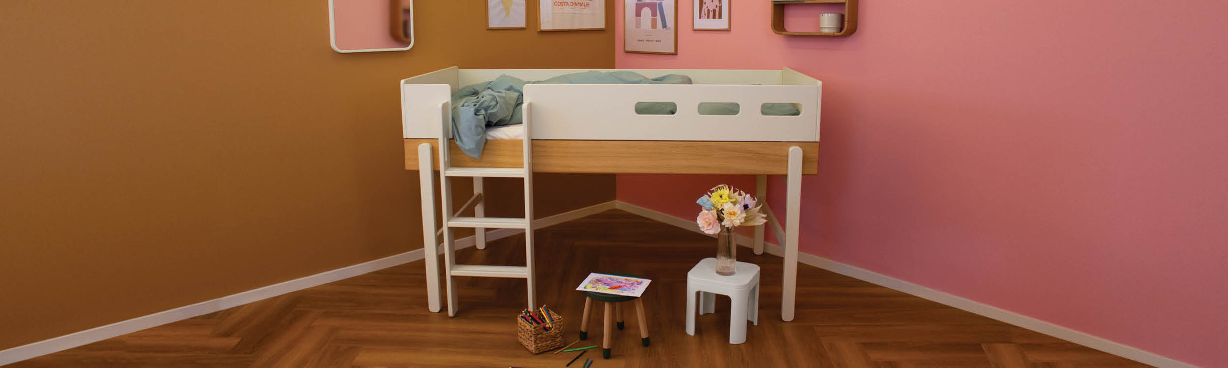 Boy in his Popsicle room with a daybed, desk and wardrobe