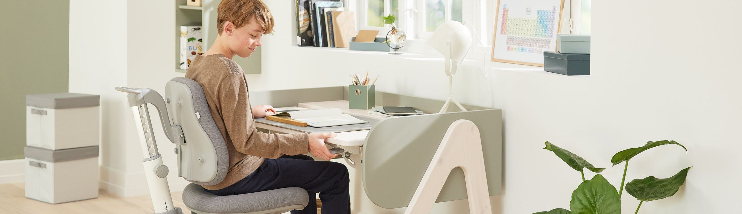 Boy studying at his study table with desk accessories from FLEXA