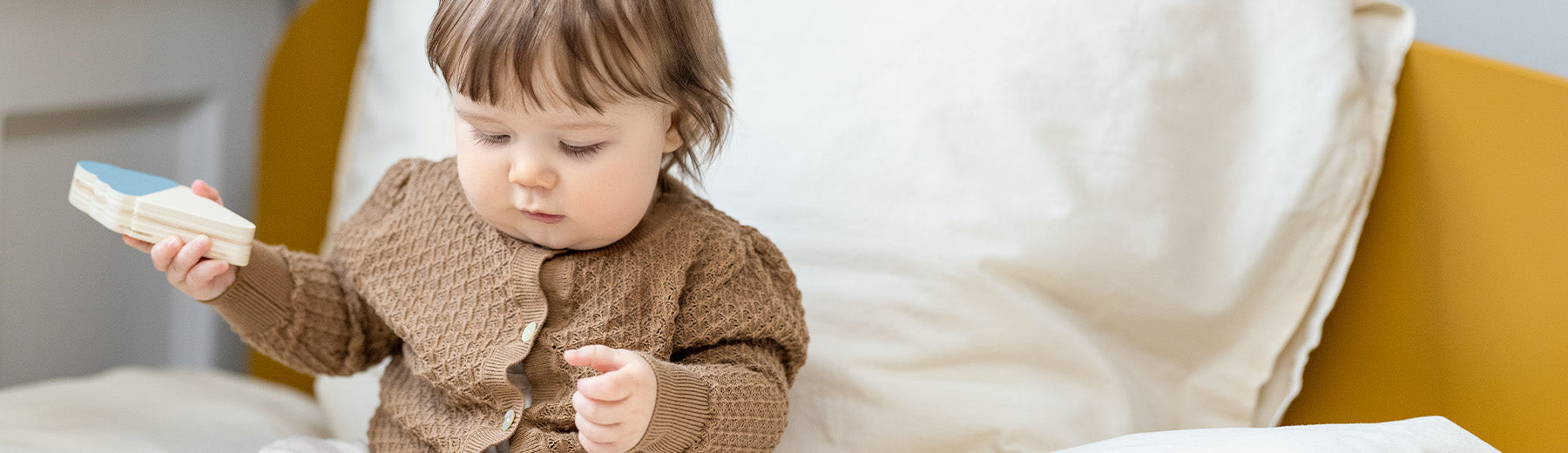 Baby playing with wooden ice cream puzzle from FLEXA