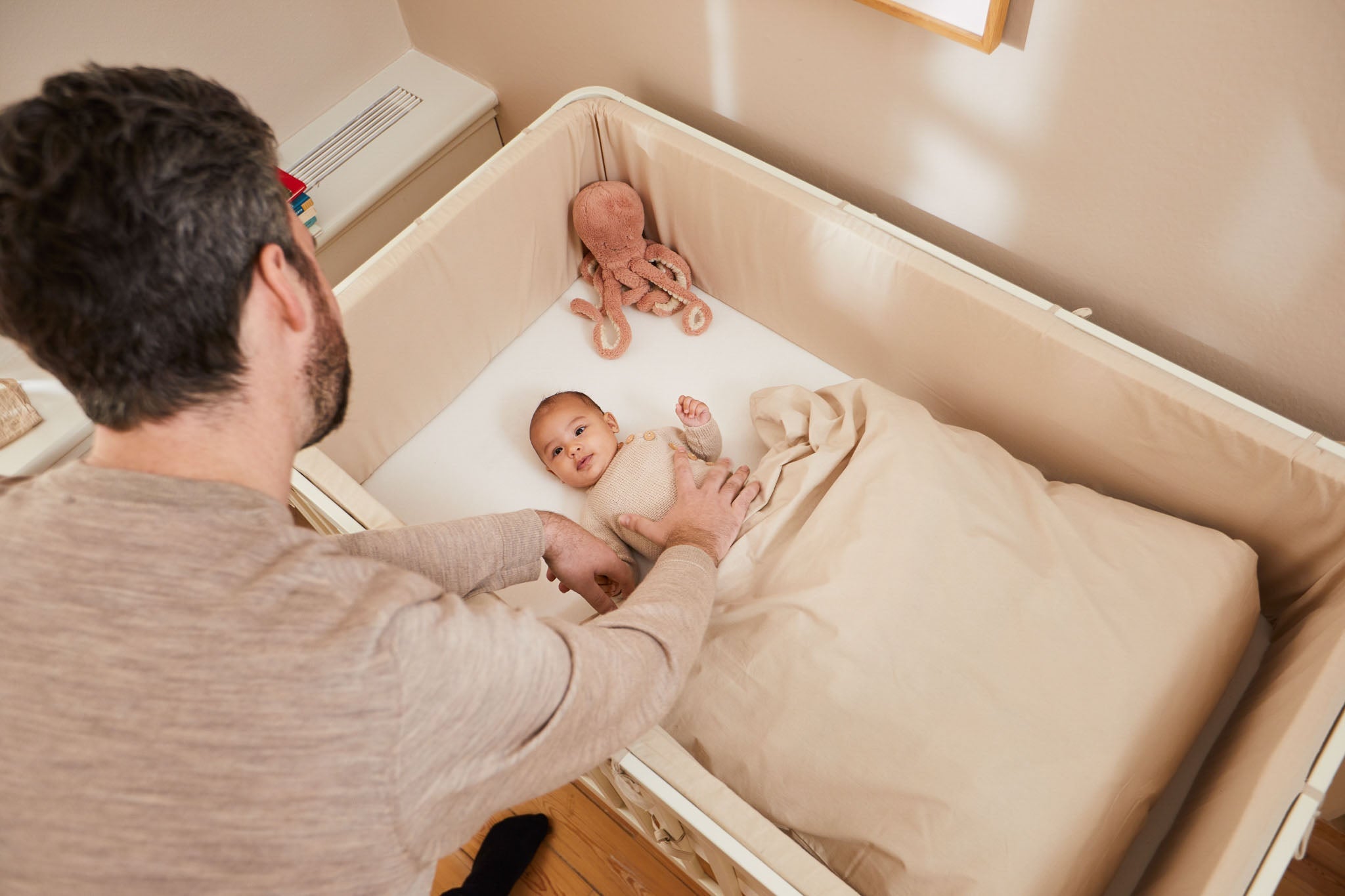 Baby lying in a FLEXA cot bed