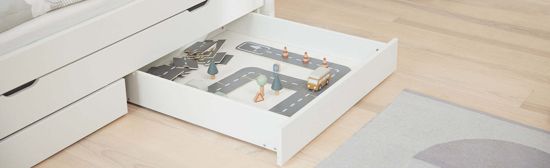a bed drawer from FLEXA with toys in it