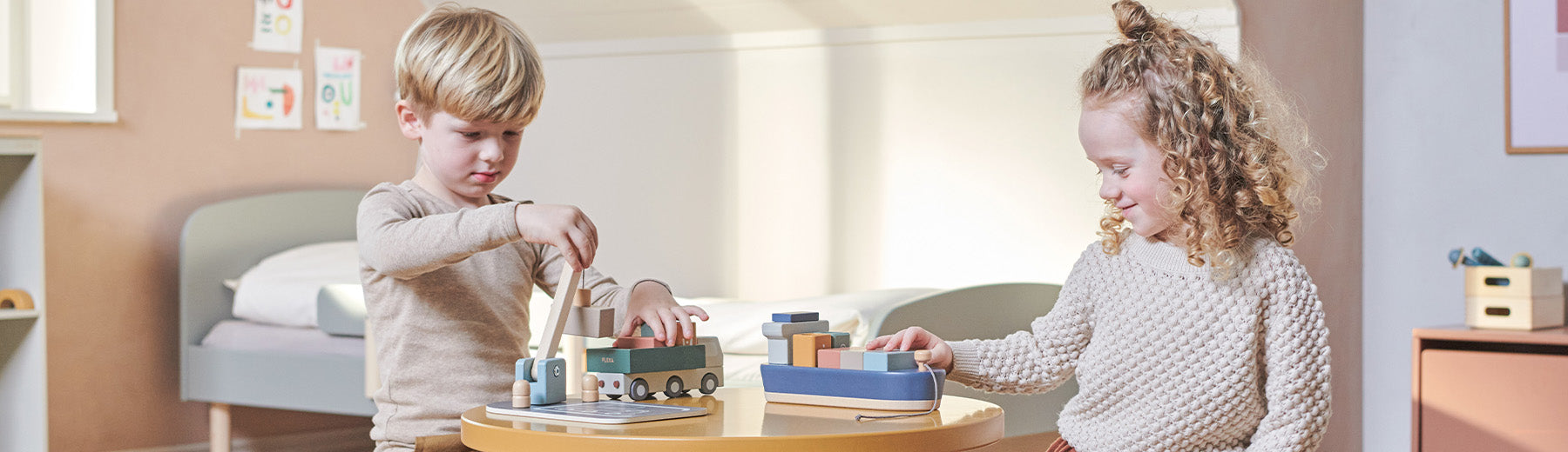 Children playing with wooden container ship and trucks from FLEXA