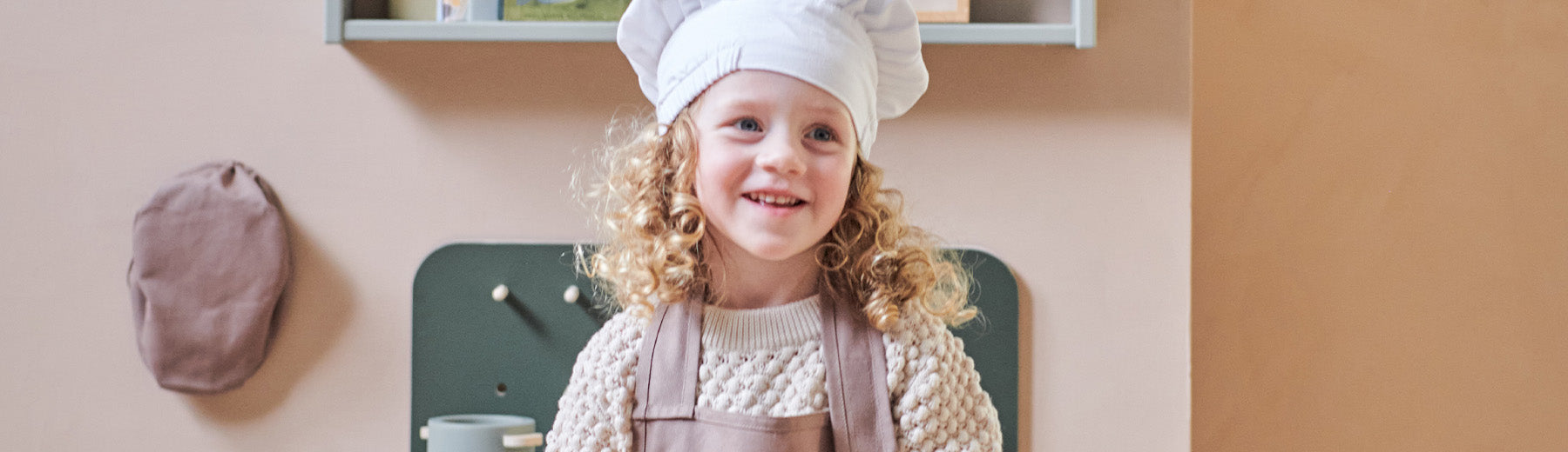Girl is dressed up in a chef costume from FLEXA