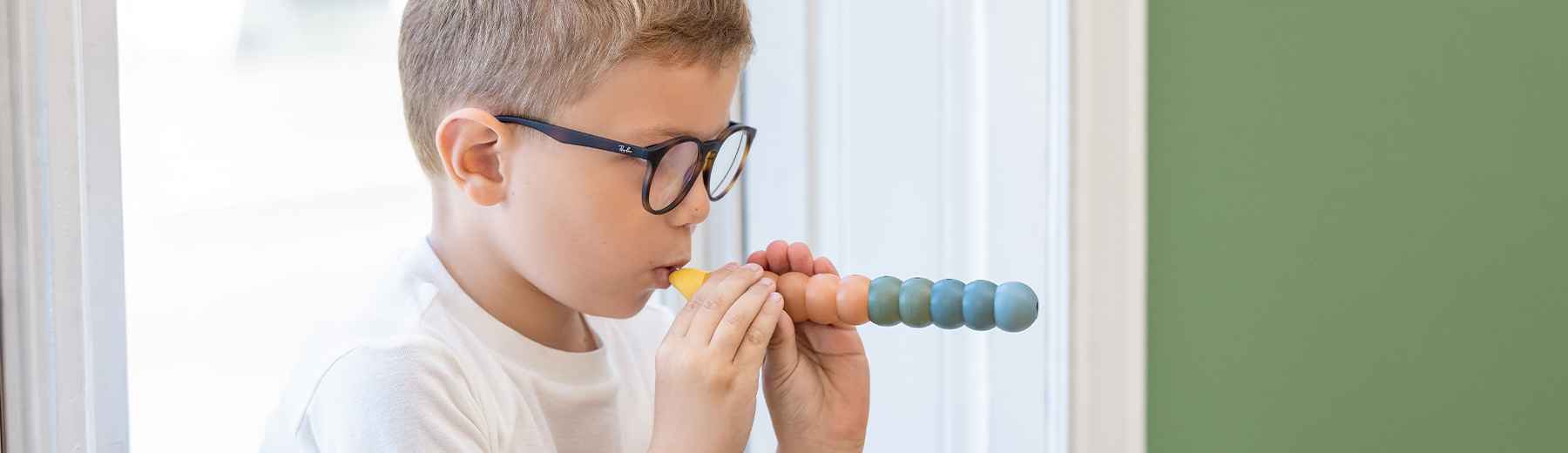 Boy is playing with a wooden flute from FLEXA