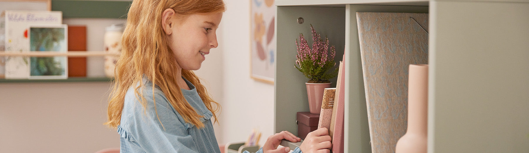 Girl standing next to bookcases from FLEXA