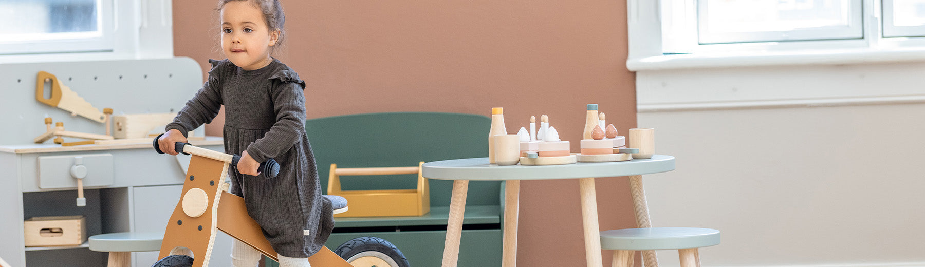 girl riding her wooden balance bike from FLEXA