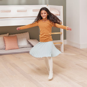Girl is dancing in front of her Nor mid high bed from FLEXA