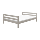 Cama individual gris FLEXA con listones horizontales y bordes seguros para los niños, mostrada sobre un fondo blanco.