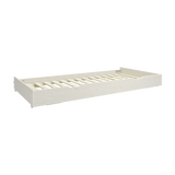 FLEXA pull-out bed from the WHITE collection in white, child-safe design with slatted base, shown in a kids’ bedroom.