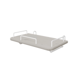 Bandeja de mesilla FLEXA de la colección GREY, de MDF gris con cuatro tiradores metálicos blancos y bordes seguros para los niños, junto a la cama.