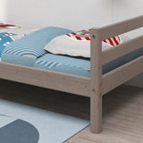 FLEXA single bed from CLASSIC collection, pine frame, blue and white striped bedding, light wood floor in child’s room.
