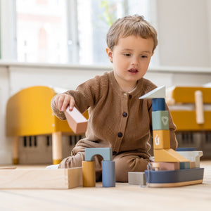 Boy playing with FLEXA Play ship and stacking toys