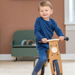 Boy is riding on a balance bike from FLEXA